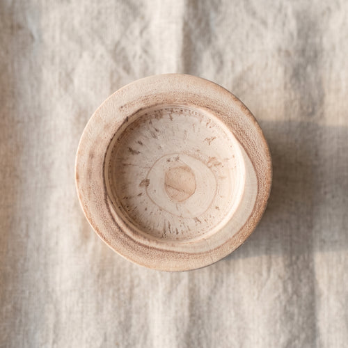 Top-down view of wooden candle holder bowl showing wood grain
